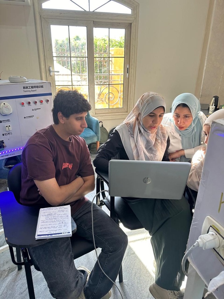 Trainees reviewing the configuration next to the training board