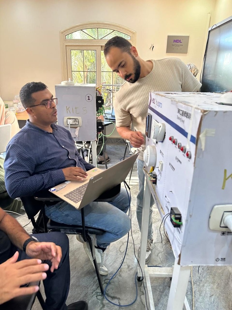 The trainer guiding a trainee at the HDL Buspro training board